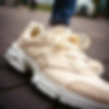 Close-up of cream sneakers showcasing intricate design