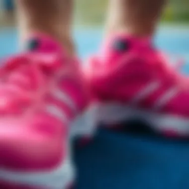 Close-up of pink volleyball shoes showcasing design features