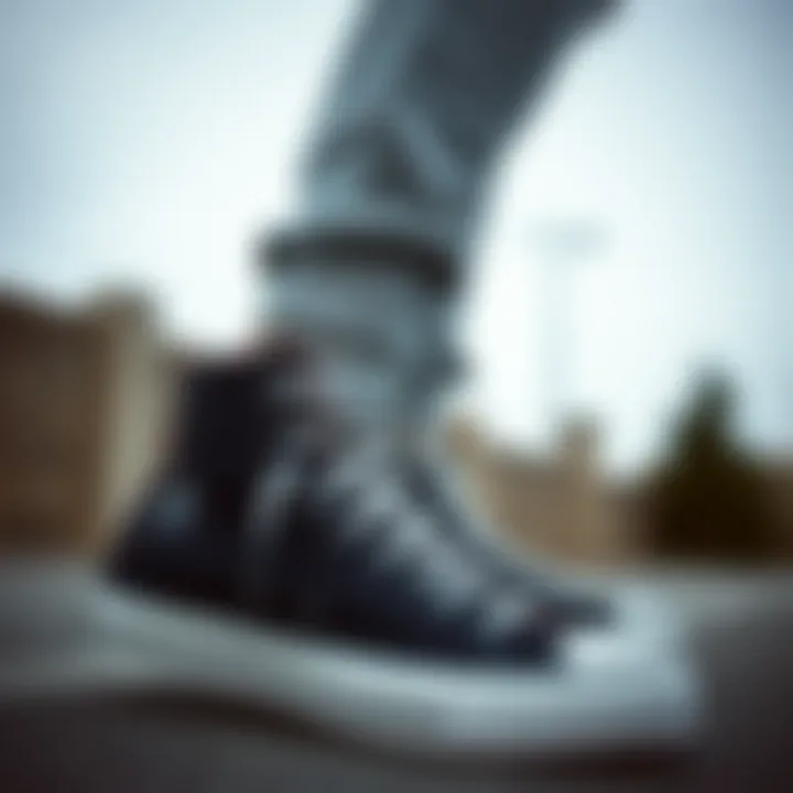 Stylish black high-top Converse shoes paired with casual athletic wear.